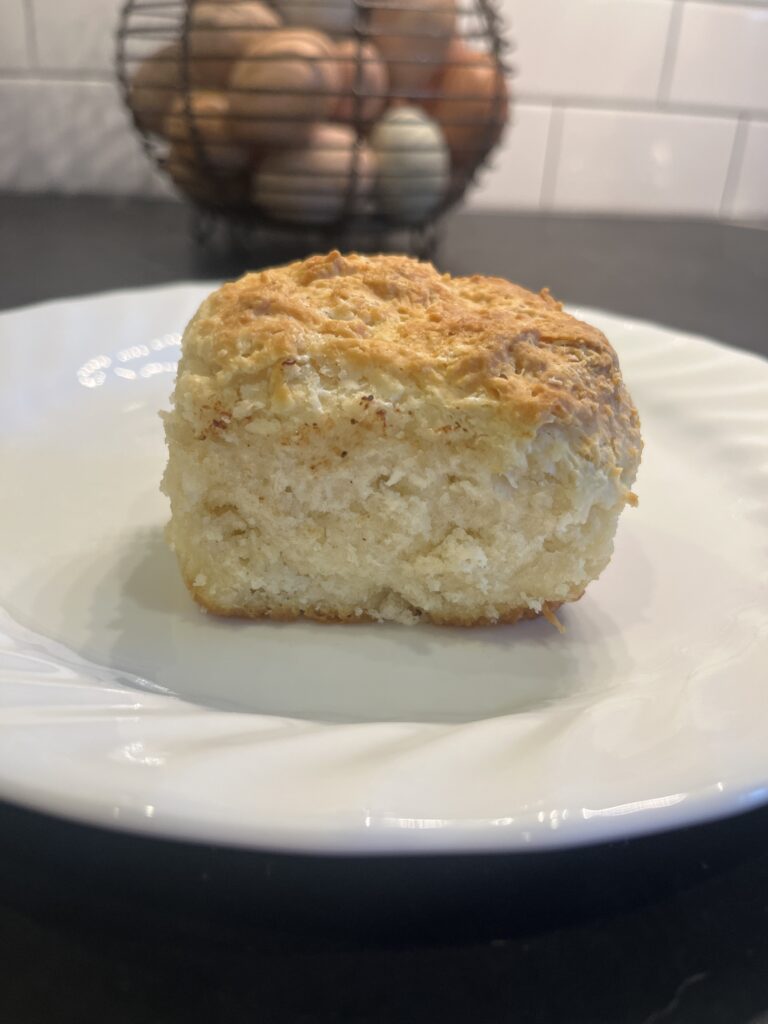 Buttermilk biscuit breakfast recipe on white plate on the counter 