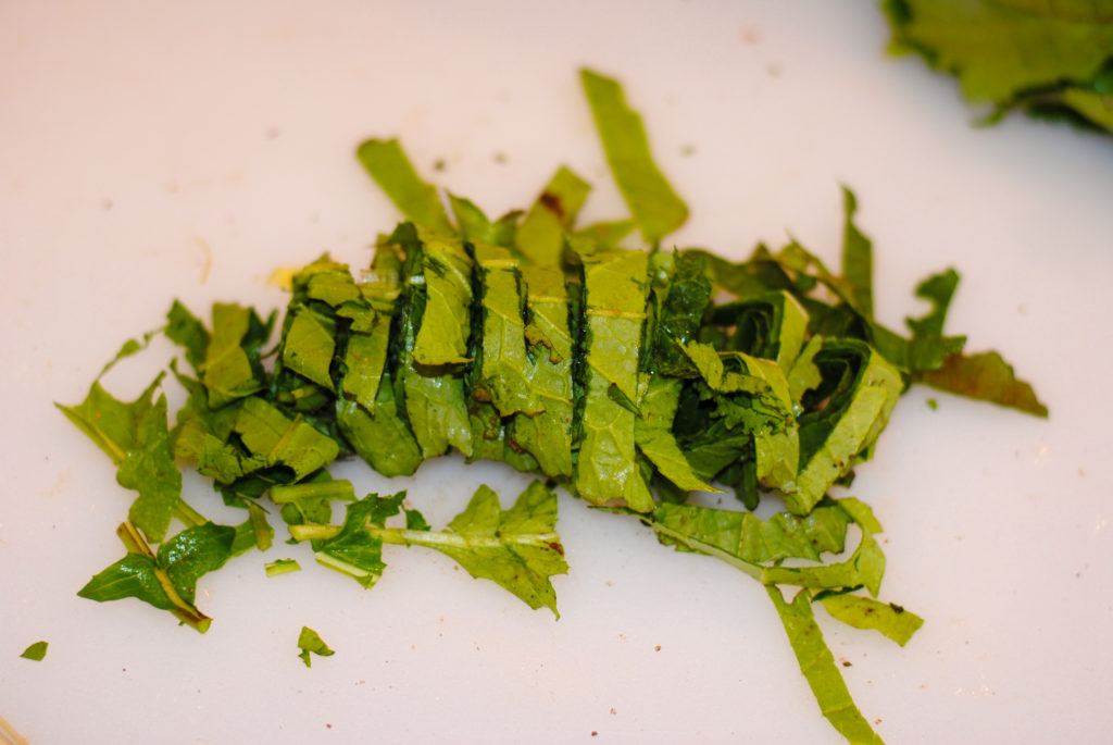 sliced turnip greens on a cutting board 