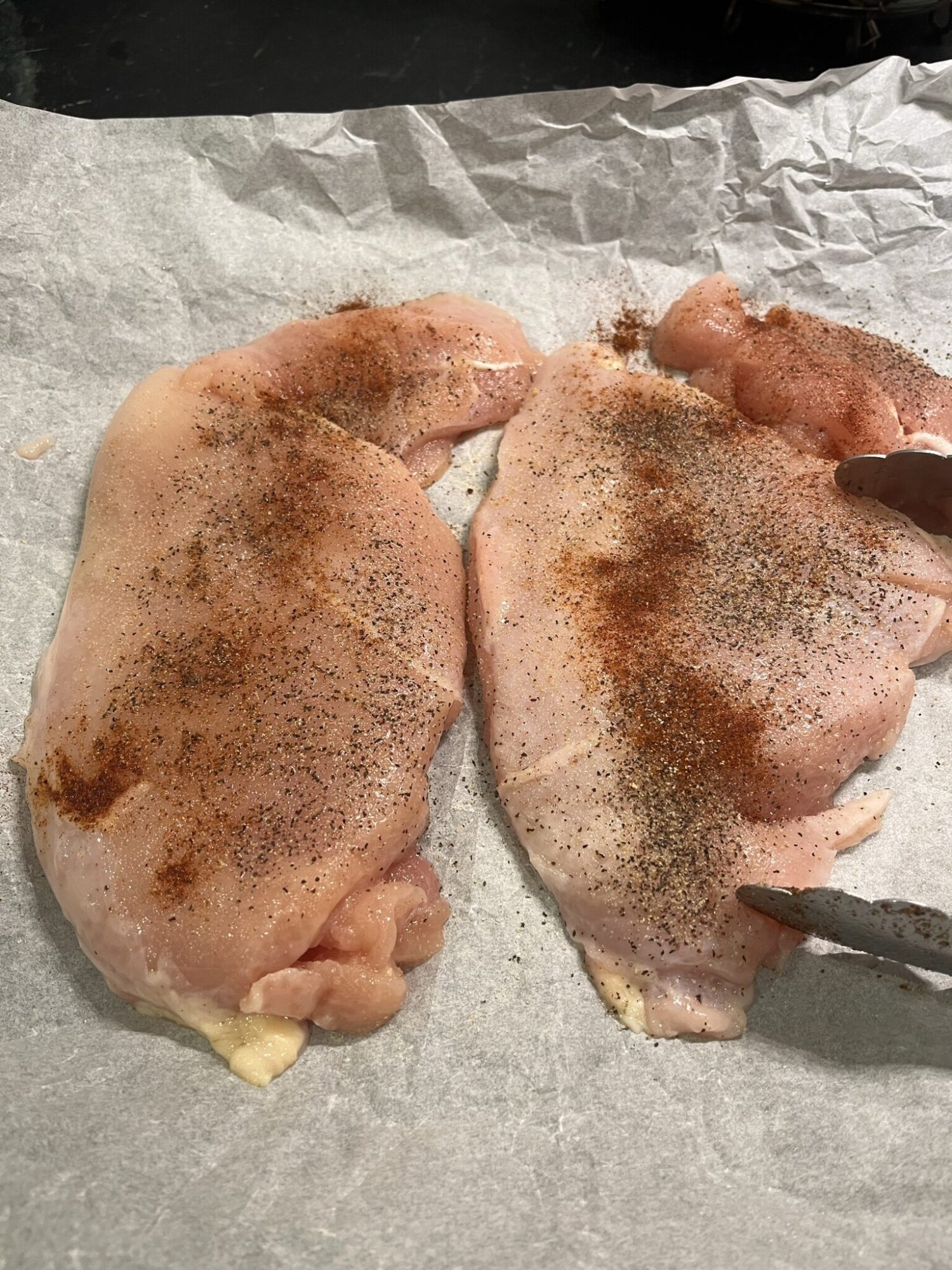 raw chicken breast with seasoning