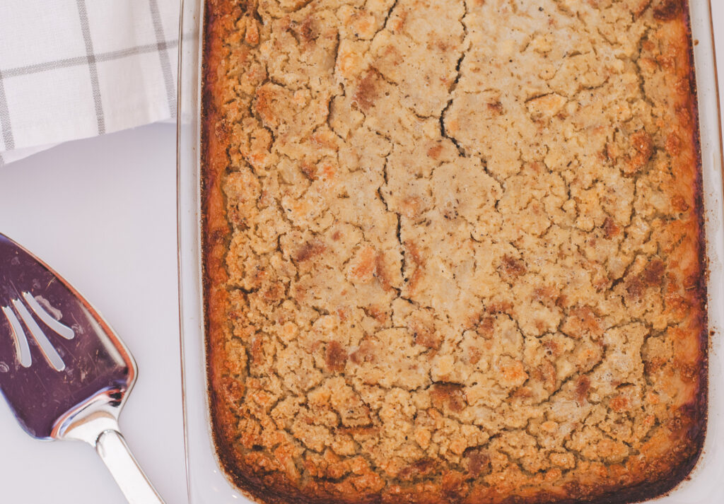 Cornbread dressing in a dish with brown top and edges. 