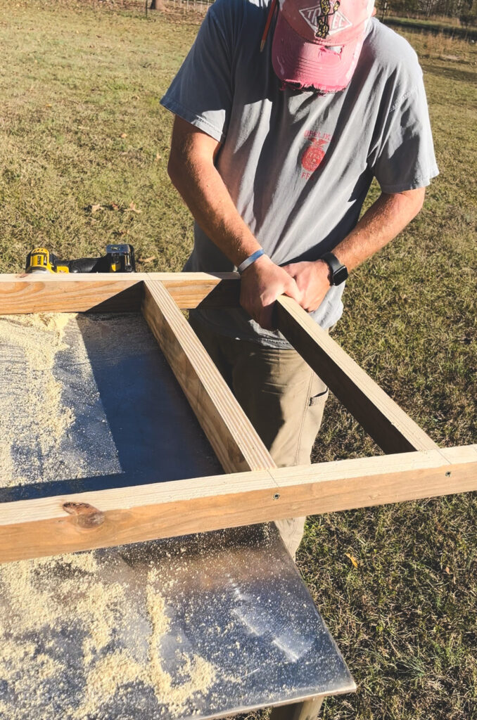 Man assembling a chicken ladder 