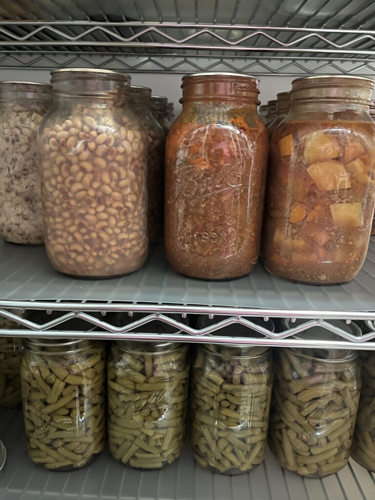 Homestead canned vegetables on a kitchen shelf