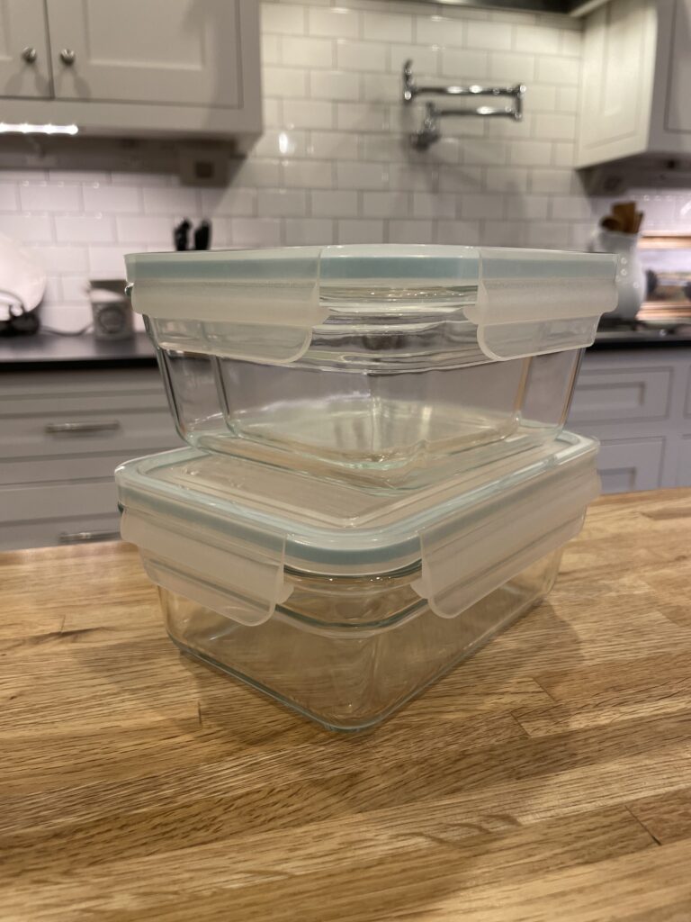 Less toxic lifestyle glass food storage containers on a counter top in a kitchen. 