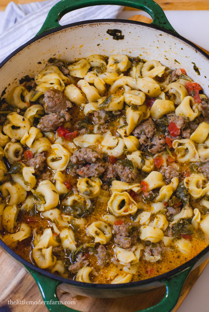 Sausage tortellini soup in a dutch oven