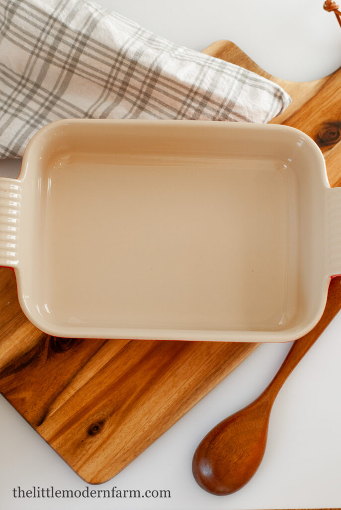 Stoneware casserole dish on a wooden cutting board 