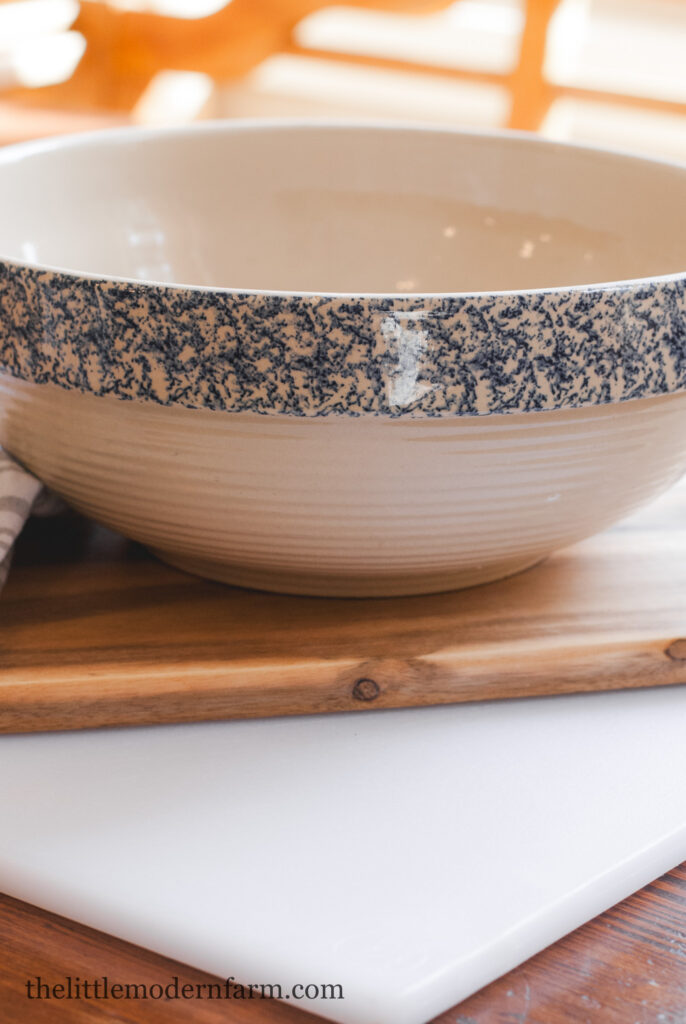 Stoneware decorative bowl with blue trim. 