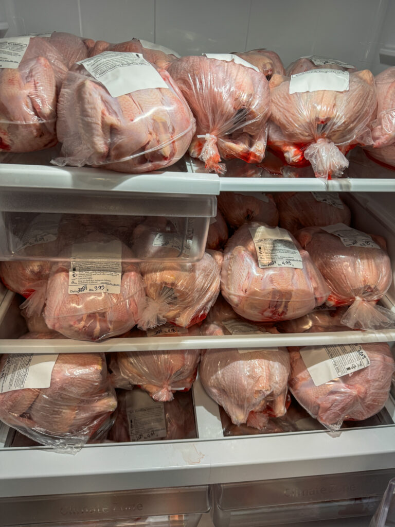 Multiple chickens being stored in the refrigerator.