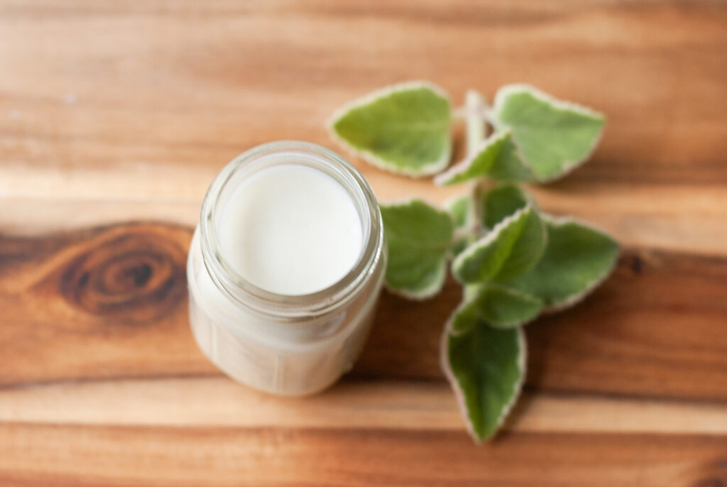 Whipped lotion on wooden surface 