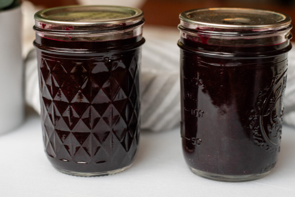 blueberry jam in two mason jars