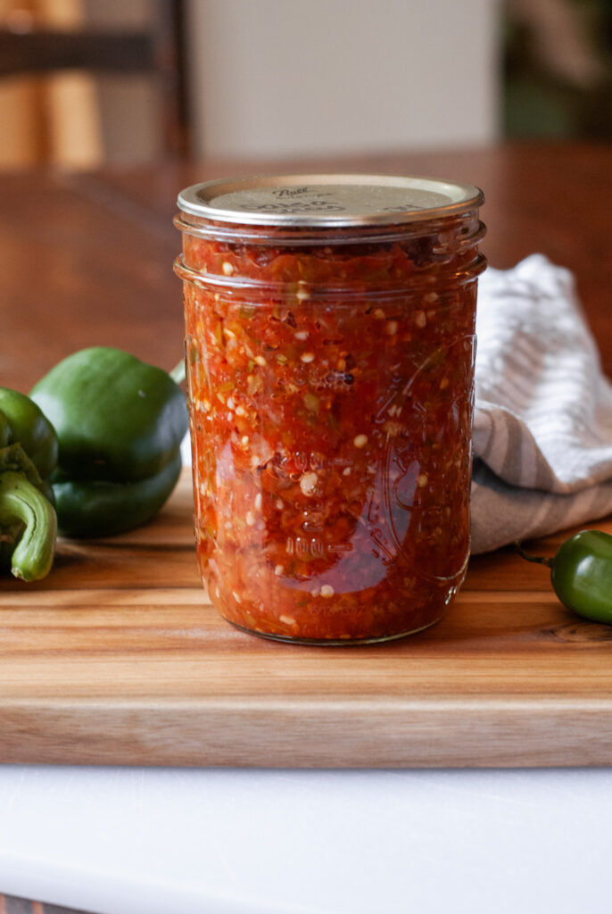 salsa in a canning jar on a wooden top