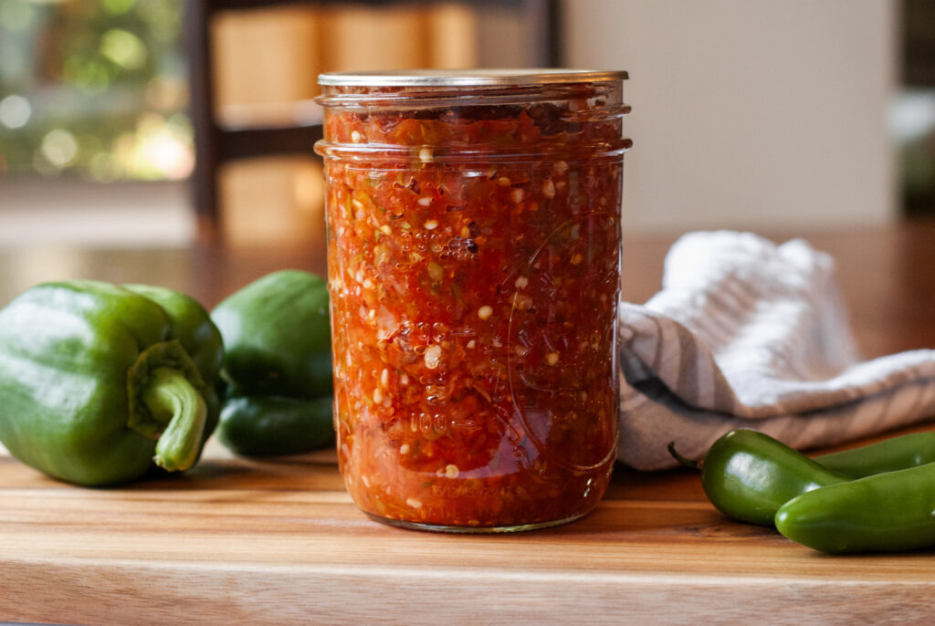 Salsa in a cannon jar on a wooden top 