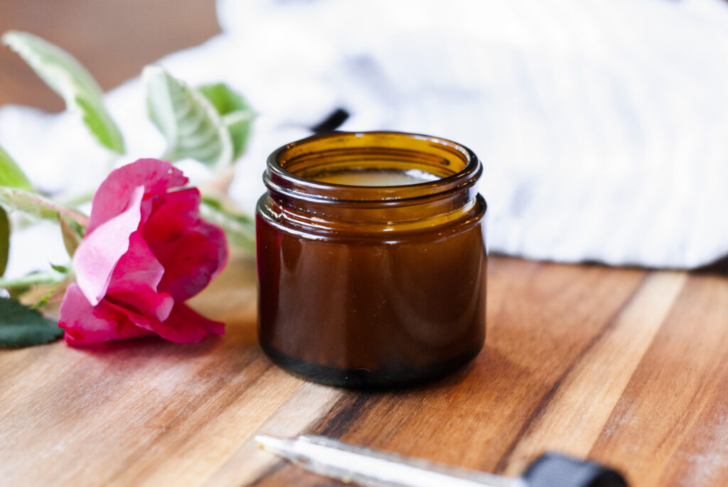 Shea butter moisturizer in an amber jar on a wooden surface 