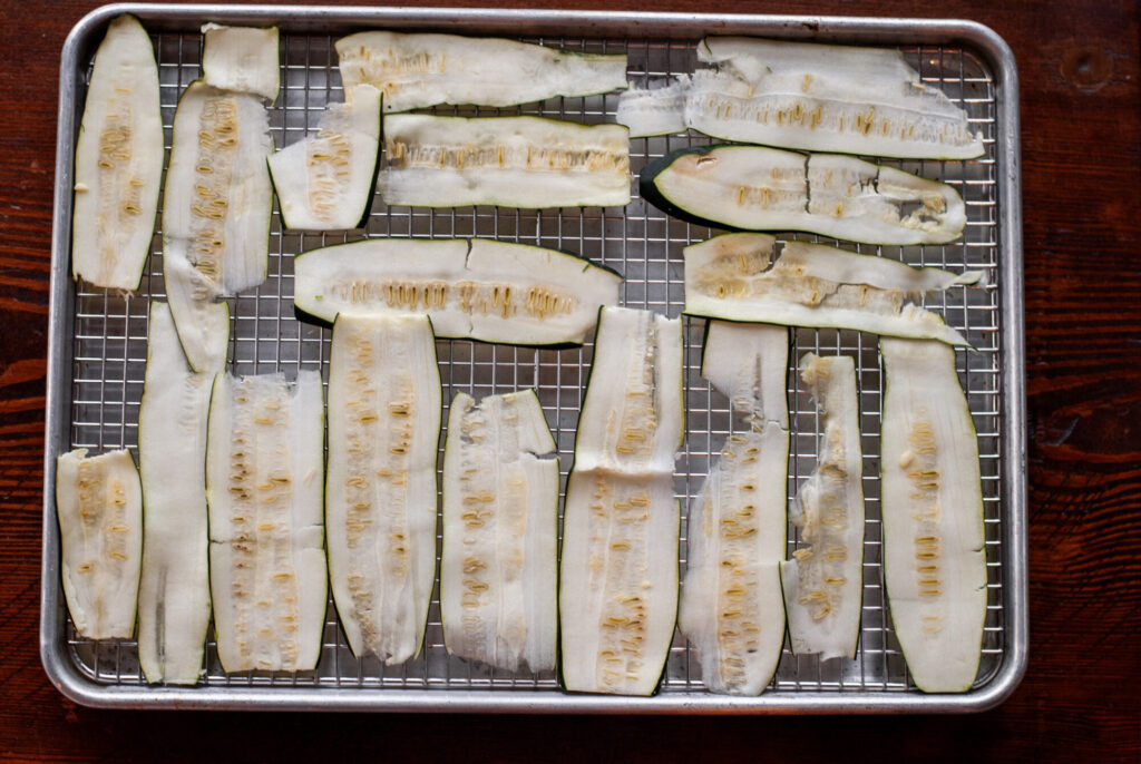 Zucchini slices on a roasting pan 