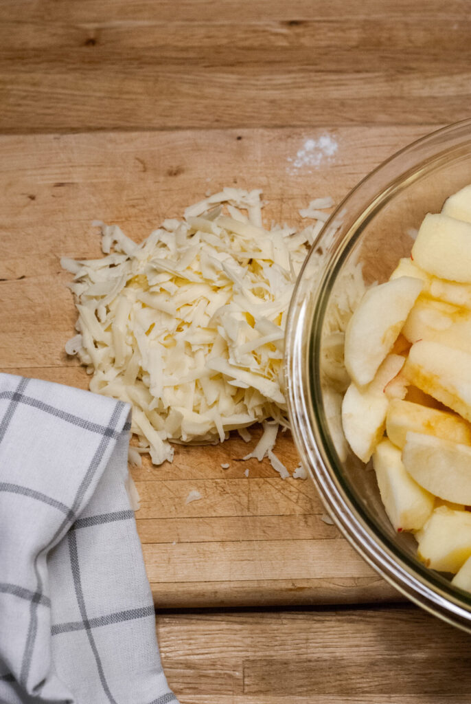 apple and cheese on a cutting board 