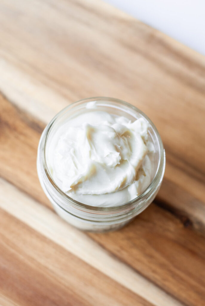 Whipped magnesium lotion on wooden counter top. 