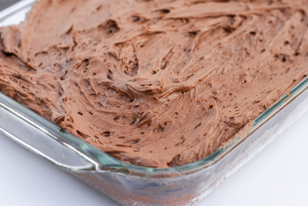 cake in a dish with chocolate frosting. 